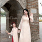 Linh Vy - Mom and Daughter Haze Cream Teardrop Cutout Red Knot Ao Dai Set